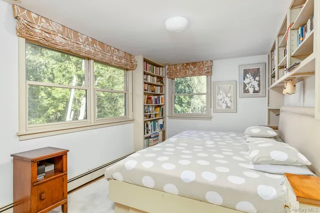 a large bed sitting in a bedroom next to a window
