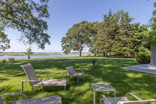 a view of a lake with lawn chairs