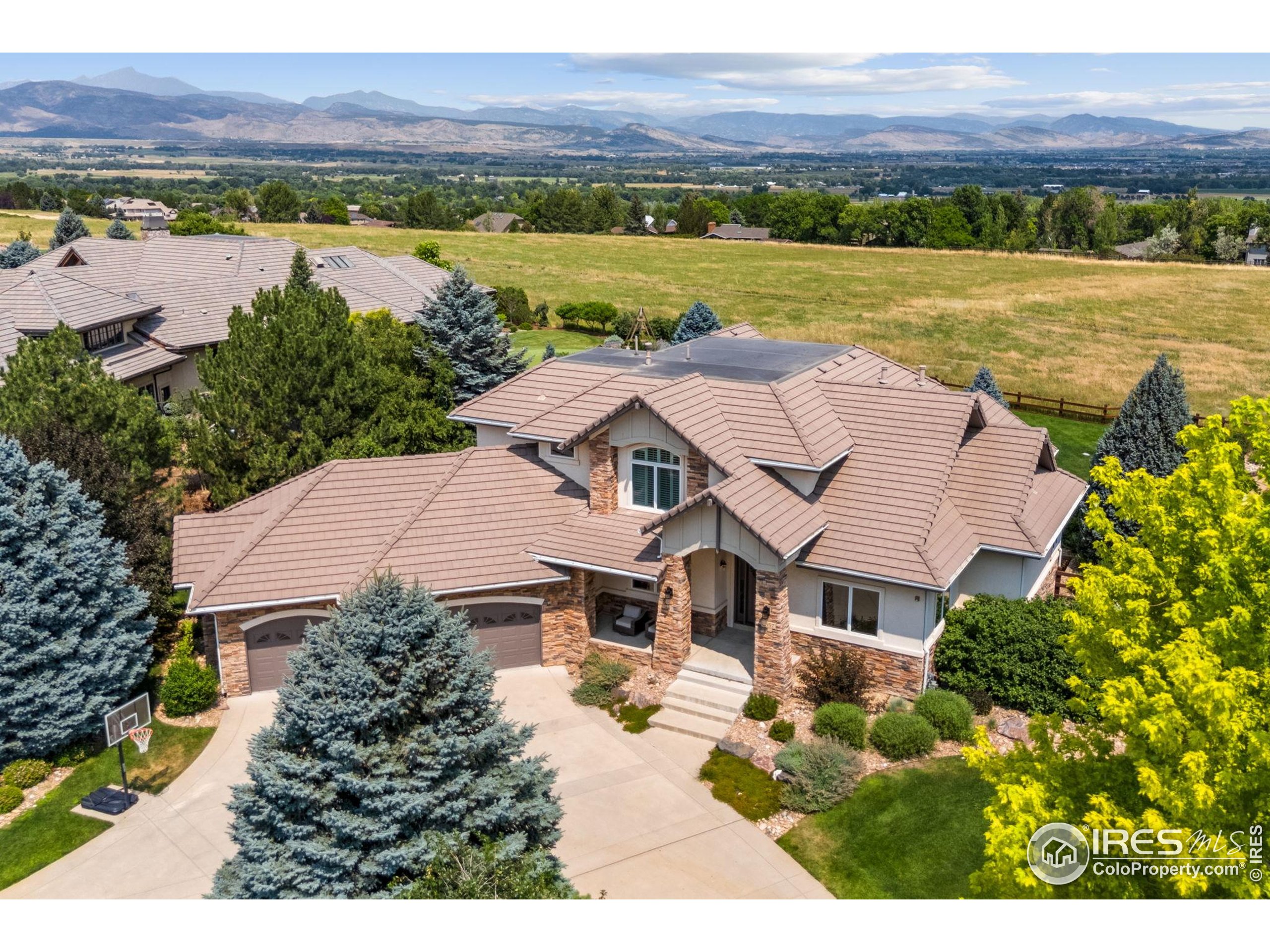 an aerial view of a house with a garden and lake view
