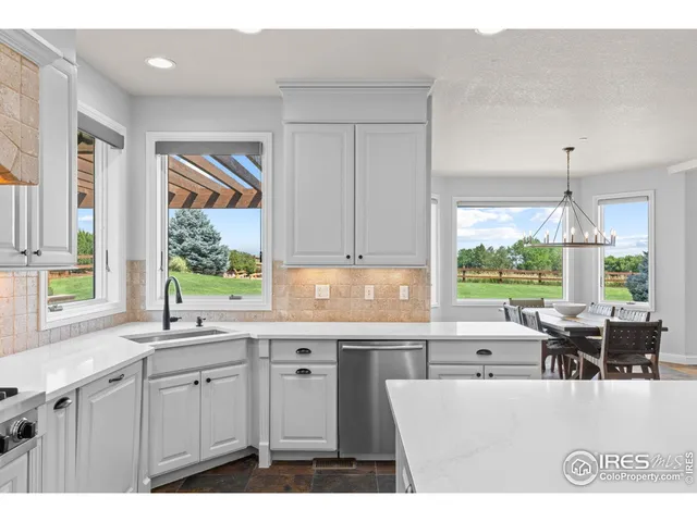 a open kitchen with granite countertop a sink window and cabinets