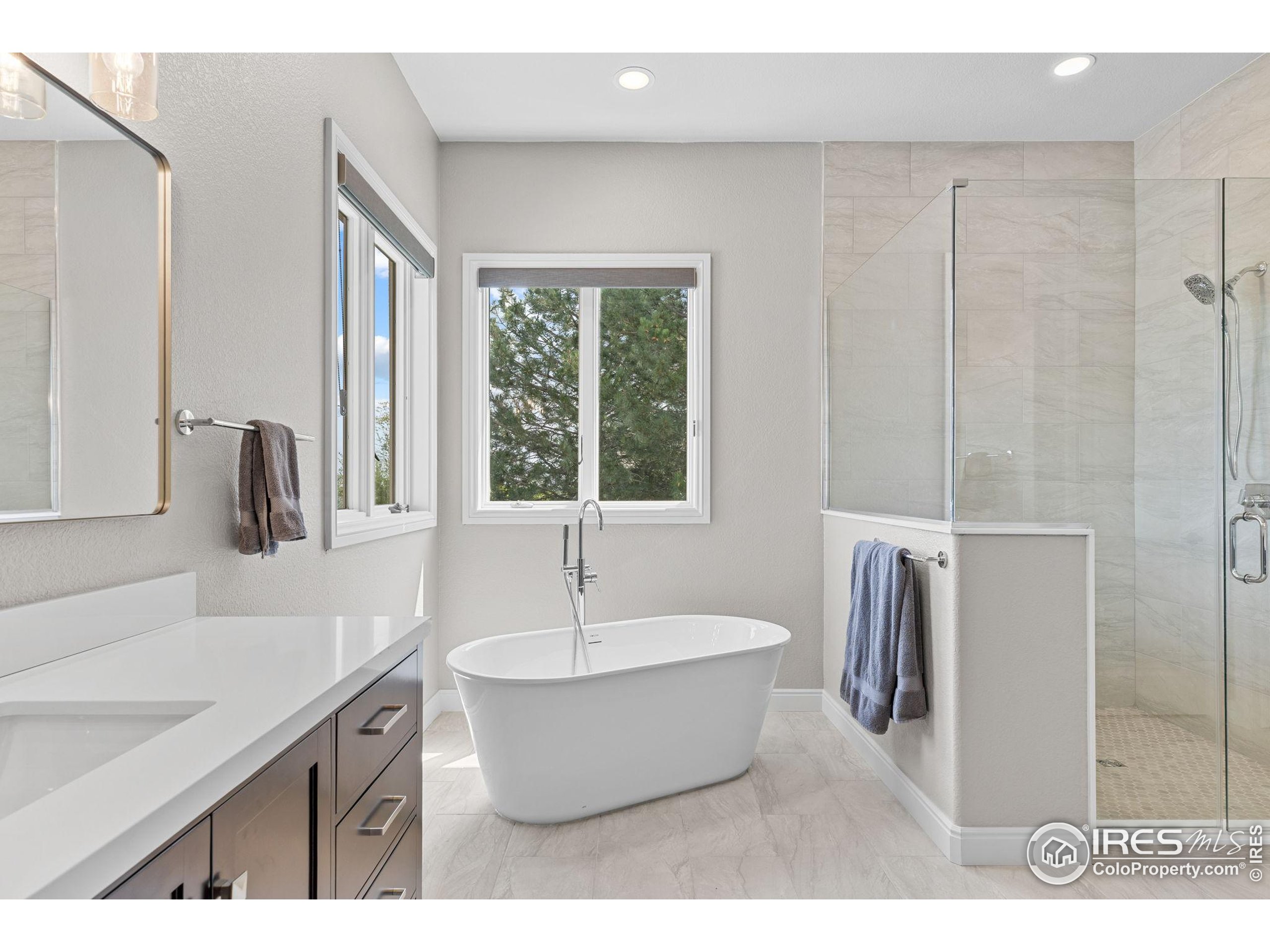 6557 Legend Ridge Trail Niwot, CO 80503 - Photo 19 of 42 a bathroom with a tub sink and mirror
