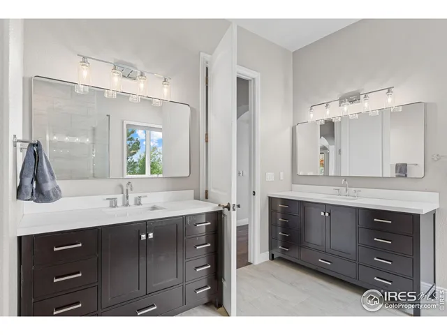 a bathroom with a granite countertop sink mirror and double