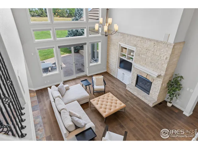 a living room with furniture wooden floor and a fireplace