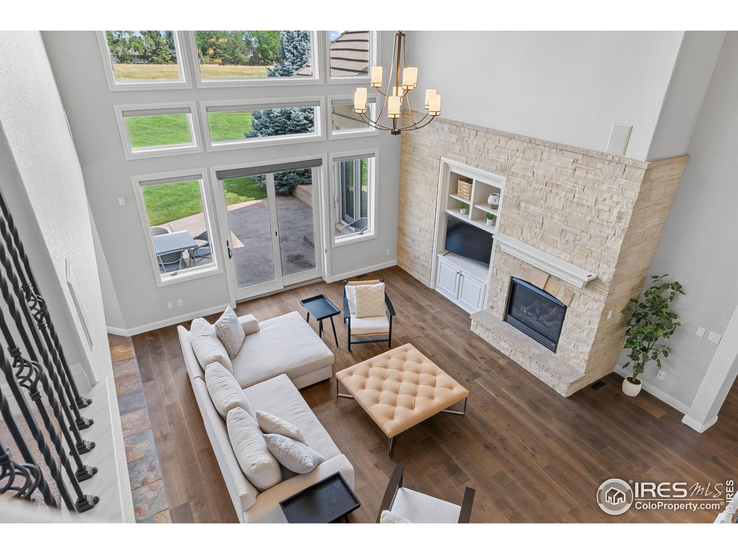 6557 Legend Ridge Trail Niwot, CO 80503 - Photo 23 of 42 a living room with furniture wooden floor and a fireplace