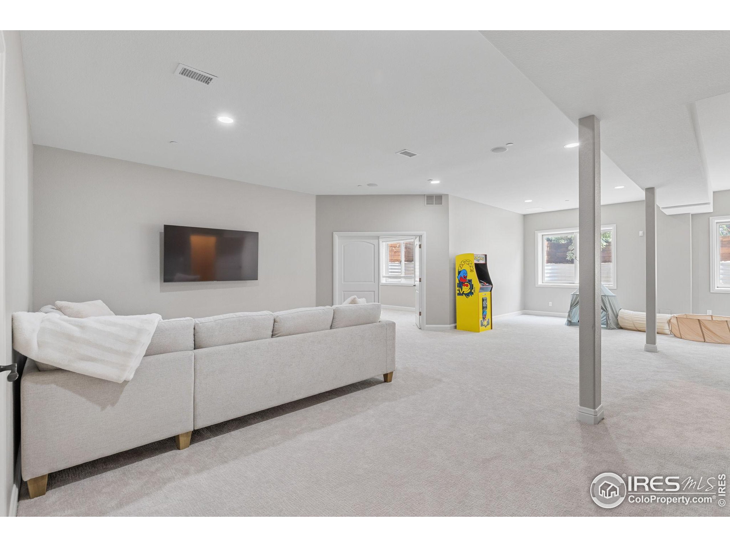 6557 Legend Ridge Trail Niwot, CO 80503 - Photo 34 of 42 a living room with furniture and a flat screen tv