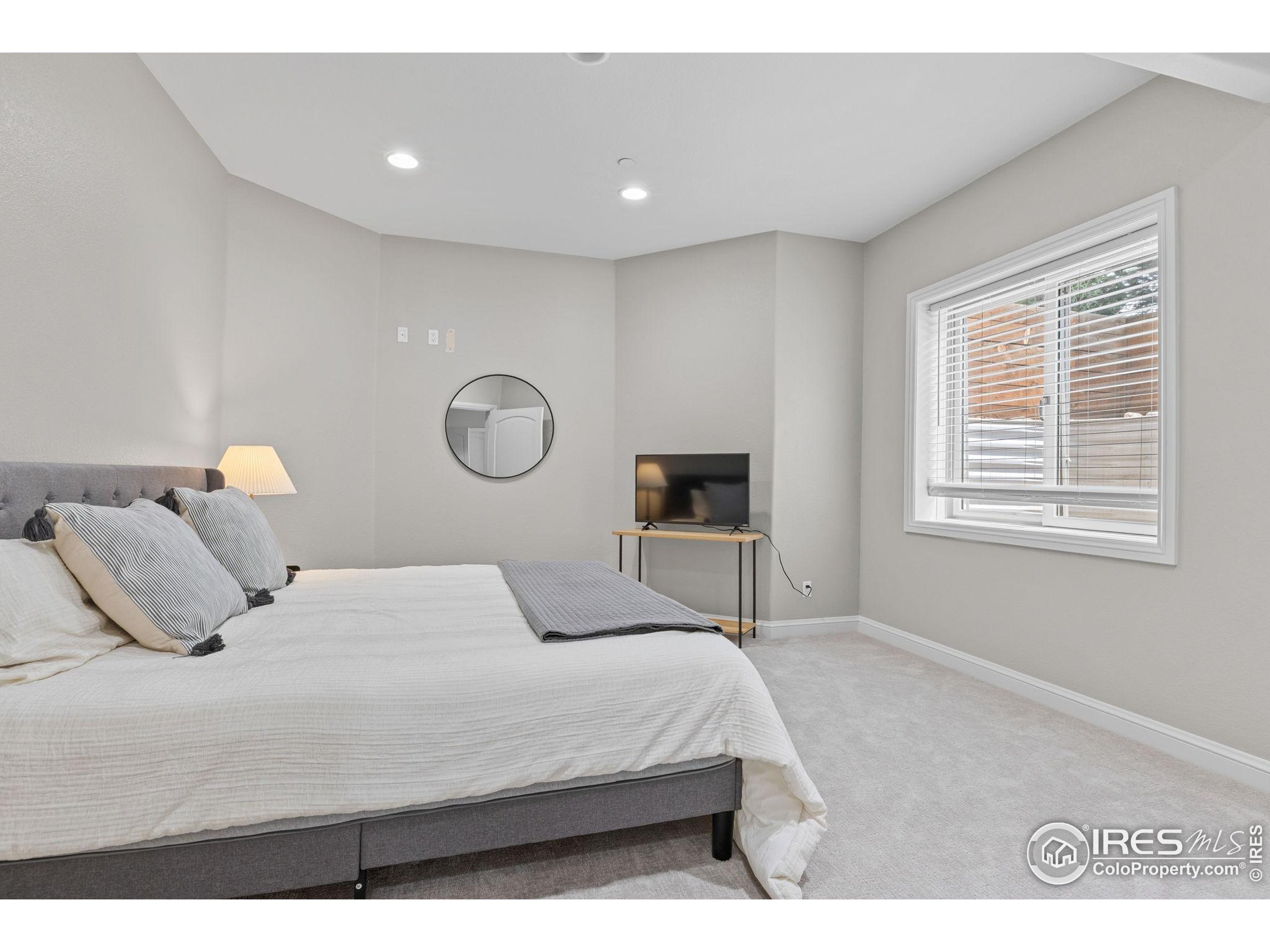 6557 Legend Ridge Trail Niwot, CO 80503 - Photo 37 of 42 a bedroom with a bed and a table