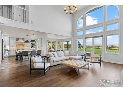 a living room with furniture and floor to ceiling windows