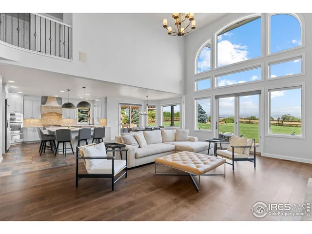 a living room with furniture and floor to ceiling windows