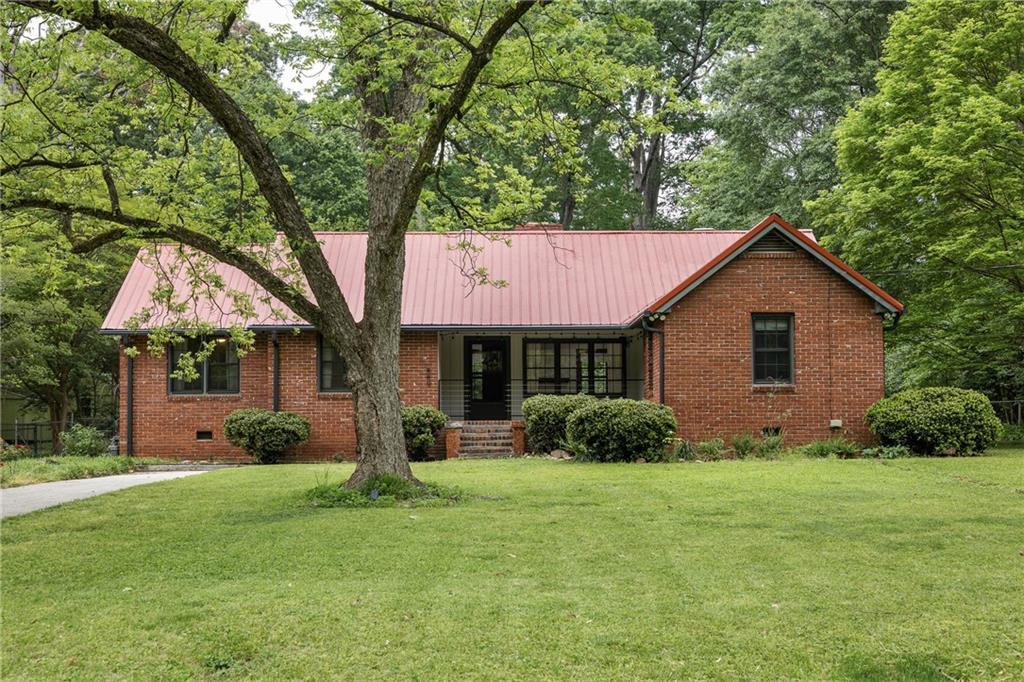 889 Milam Circle Clarkston, GA 30021 - Photo 1 of 1 a front view of a house with yard and green space