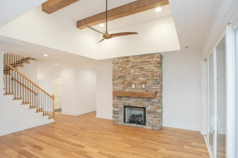 a view of empty room with fireplace and fan