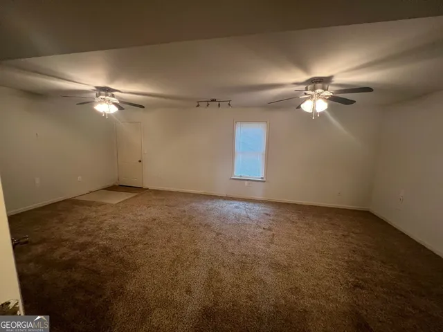 a kitchen with a checkered floor and white cabinets