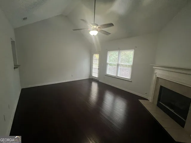 a view of wooden floor and fire place in a room