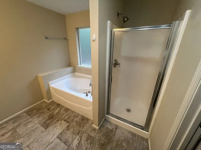 a bathroom with a tub and a shower