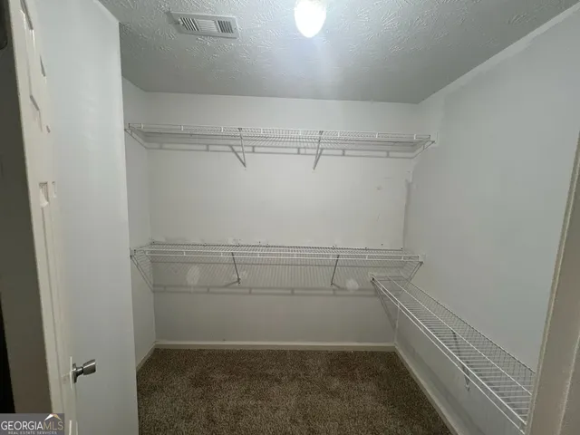 a view of a room with racks on the wall
