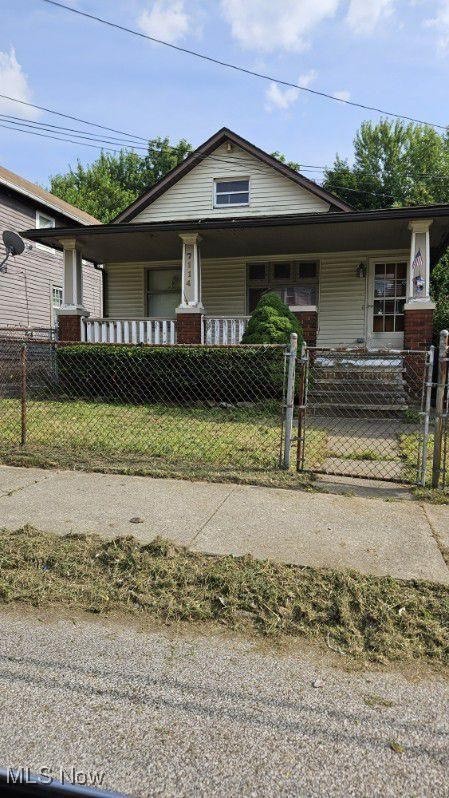 7114 Ottawa Road Cleveland, OH 44105 - Photo 1 of 1 View of front facade with covered porch, a fenced front yard, and a gate