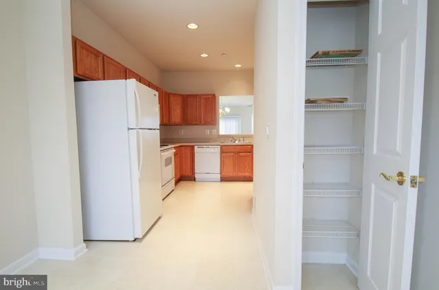 a kitchen with stainless steel appliances a refrigerator and a cabinets
