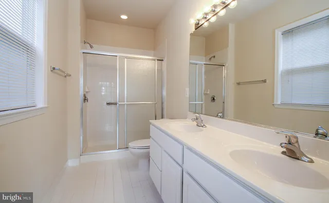 a bathroom with a sink a shower and a mirror