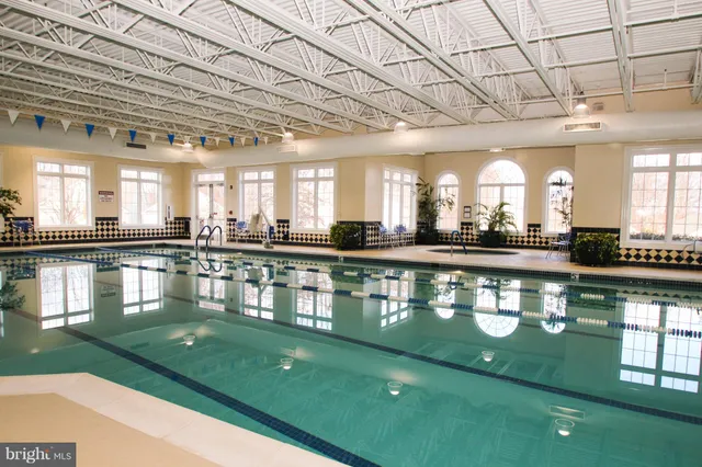 a large white kitchen with a large window