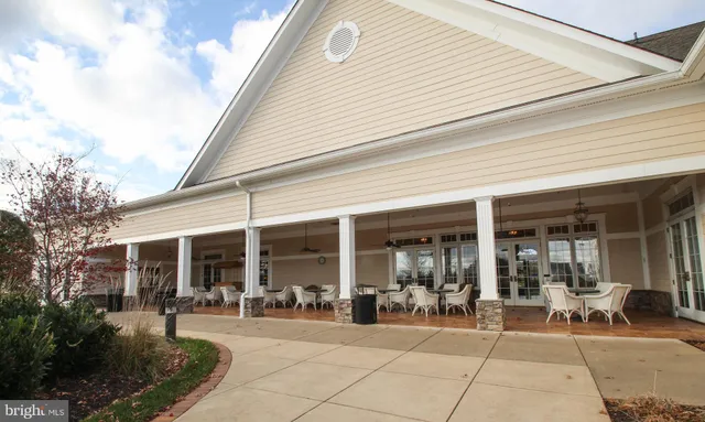 a view of a house with backyard porch and sitting area