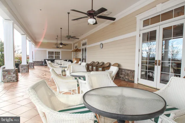 a living room with furniture a chandelier and a large window
