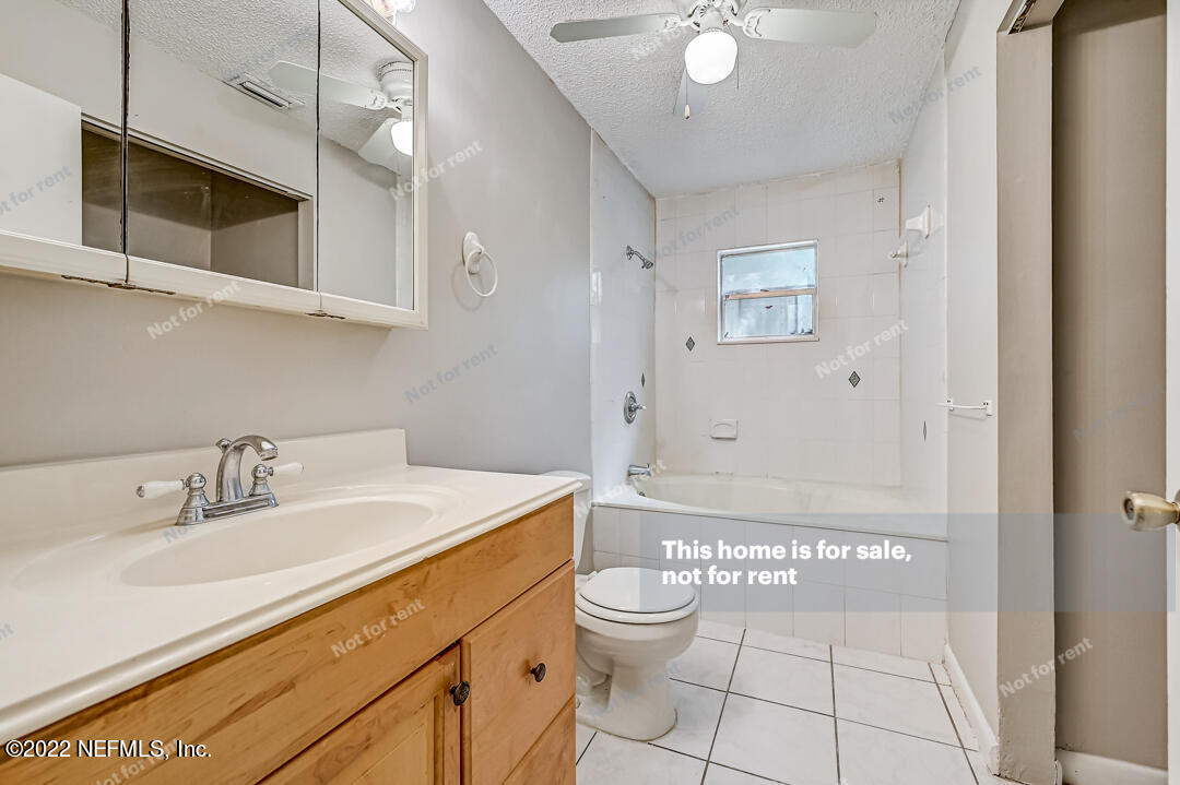 439 Lobelia Road St. Augustine, FL 32086 - Photo 8 of 26 a bathroom with a sink a toilet and shower