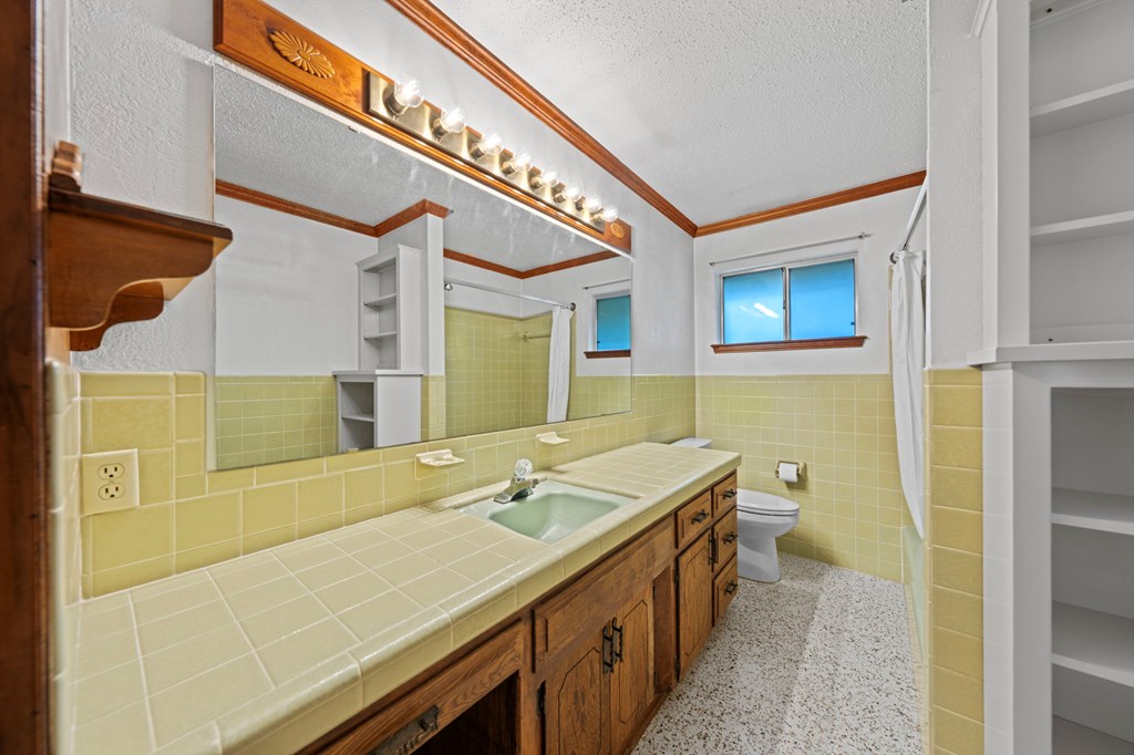 133 Oak Way Kerrville, TX 78028 - Photo 14 of 26 a bathroom with a granite countertop sink and a mirror