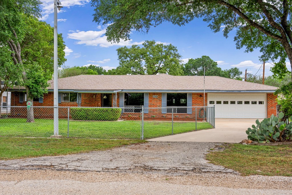 133 Oak Way Kerrville, TX 78028 - Photo 2 of 26 a front view of a house with a yard and garage