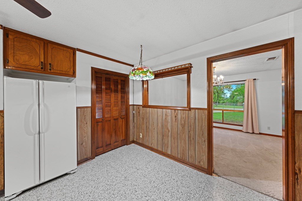 133 Oak Way Kerrville, TX 78028 - Photo 10 of 26 a view of a hallway to an entryway with wooden floor and cabinet