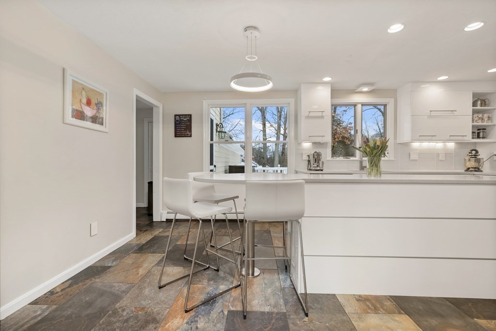 100 Manatee Road Hingham, MA 02043 - Photo 12 of 38 a dining hall with stainless steel appliances kitchen island granite countertop a sink and cabinets