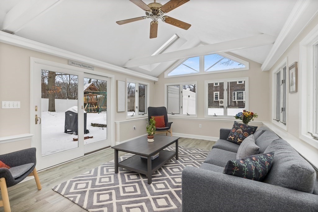100 Manatee Road Hingham, MA 02043 - Photo 17 of 38 a living room with furniture a wooden floor and a chandelier