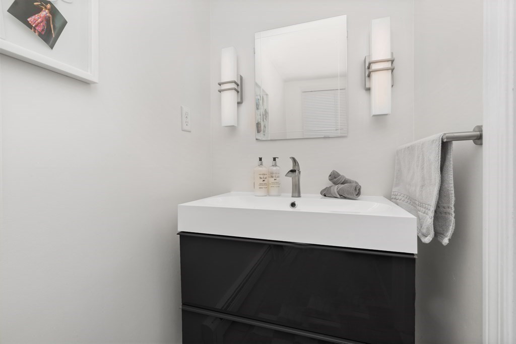100 Manatee Road Hingham, MA 02043 - Photo 22 of 38 a close up of a sink and a mirror in a room