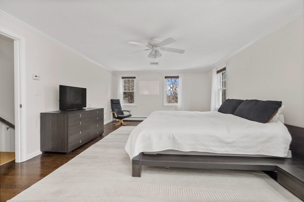 100 Manatee Road Hingham, MA 02043 - Photo 24 of 38 a spacious bedroom with a bed and a flat screen tv