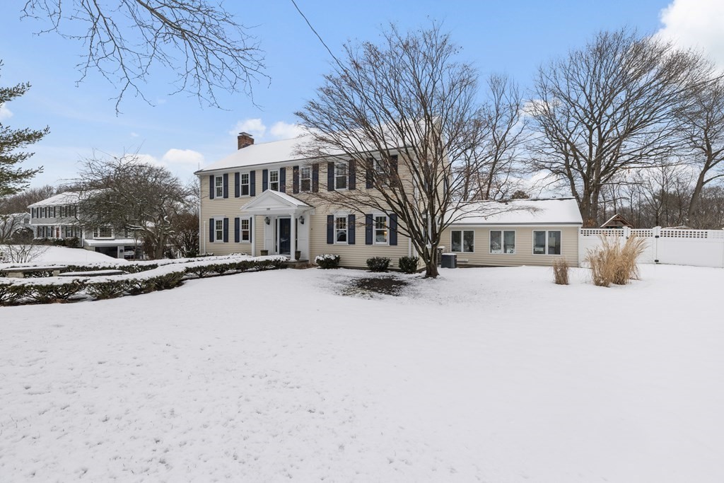 100 Manatee Road Hingham, MA 02043 - Photo 3 of 38 a view of white house with a yard covered in snow