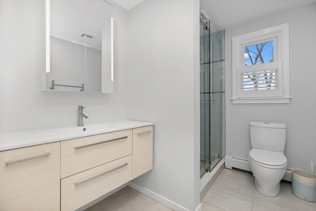 100 Manatee Road Hingham, MA 02043 - Photo 31 of 38 a bathroom with a toilet a sink and mirror