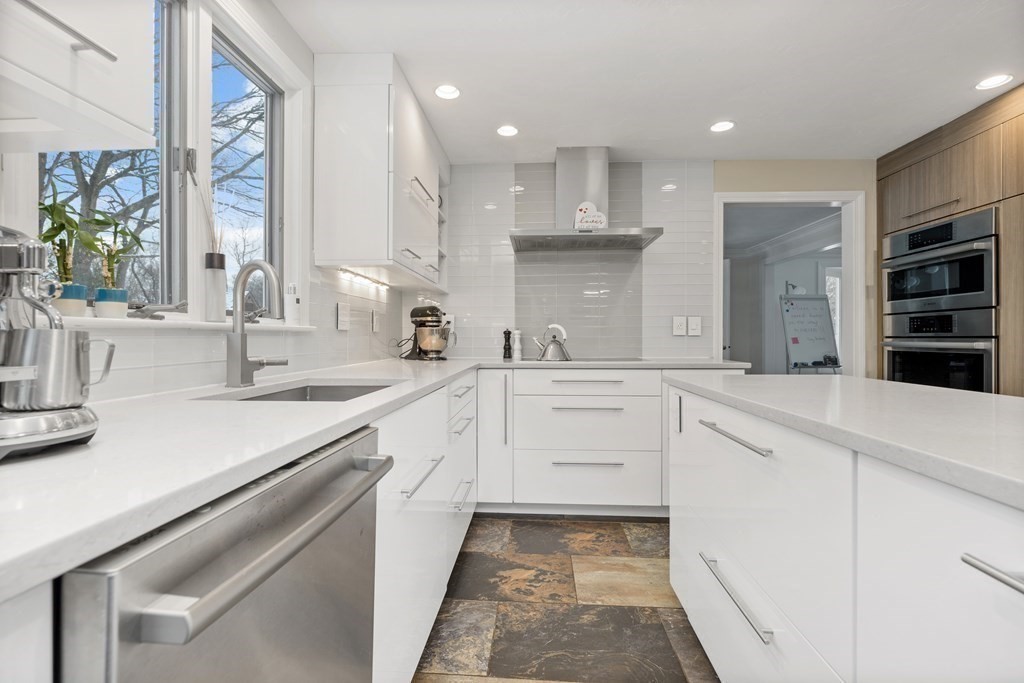 100 Manatee Road Hingham, MA 02043 - Photo 8 of 38 a kitchen with kitchen island white cabinets and refrigerator
