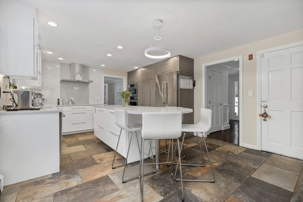 100 Manatee Road Hingham, MA 02043 - Photo 10 of 38 a large kitchen with a table and chairs