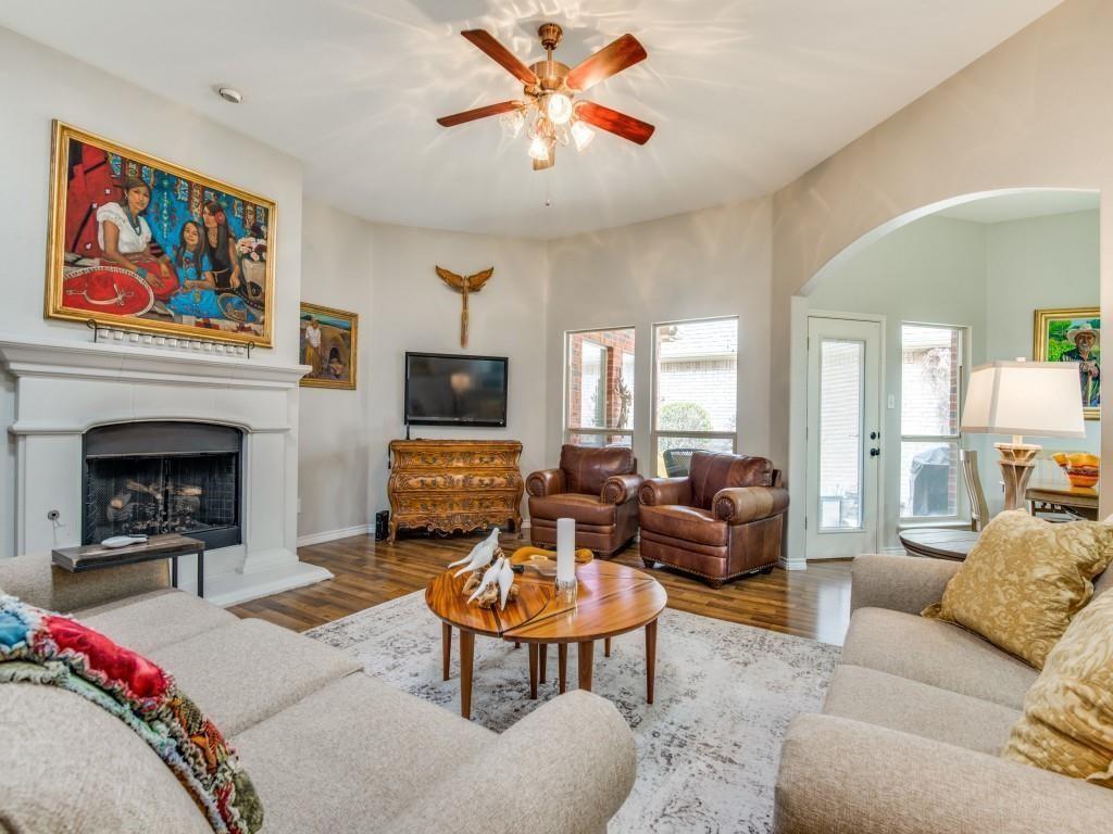 9962 Bell Rock Road Frisco, TX 75035 - Photo 9 of 28 a living room with furniture a flat screen tv and a fireplace