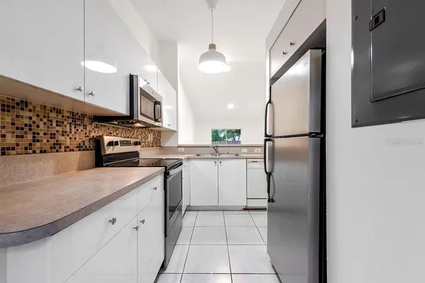 a kitchen with a refrigerator a sink and a stove