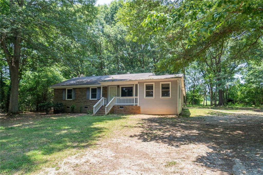 2644 Old Buckhead Road Madison, GA 30650 - Photo 1 of 1 a view of a house in front of a big yard with large trees