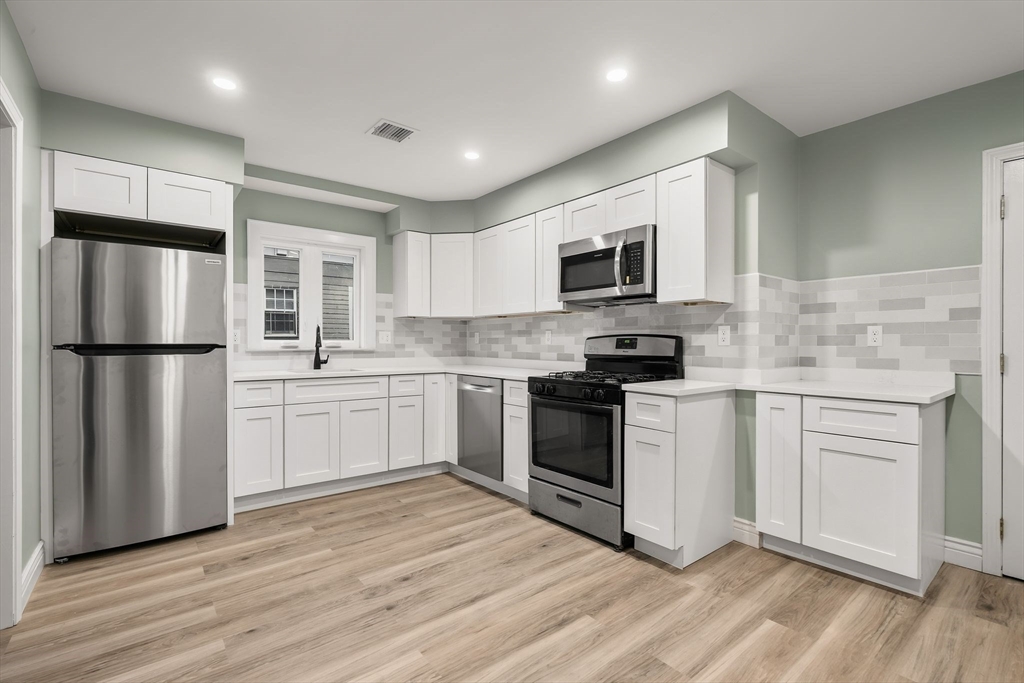 8 1/2 Intervale Street, Unit 10 1/2 Quincy, MA 02169 - Photo 1 of 16 a kitchen with a refrigerator stove and microwave