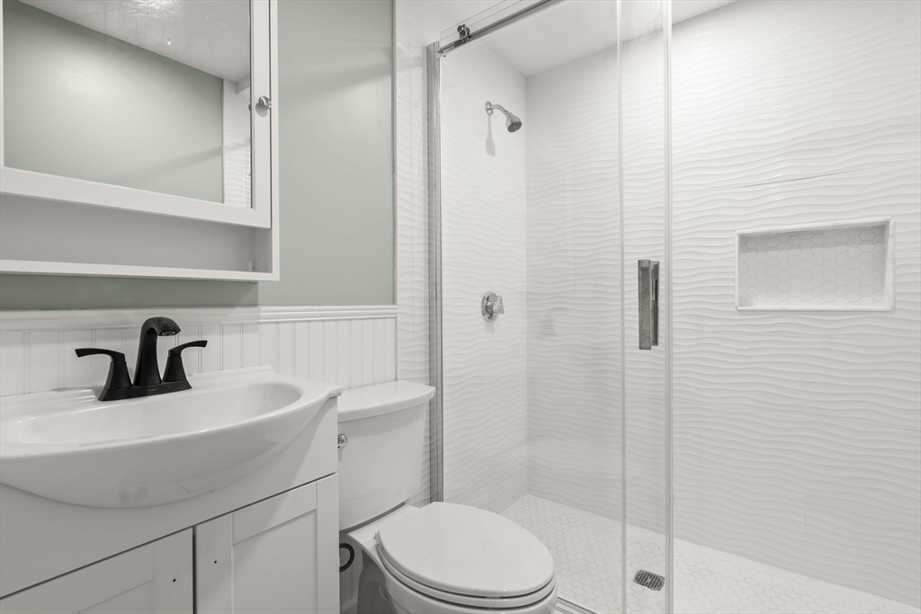 8 1/2 Intervale Street, Unit 10 1/2 Quincy, MA 02169 - Photo 12 of 16 a bathroom with a sink a toilet and shower