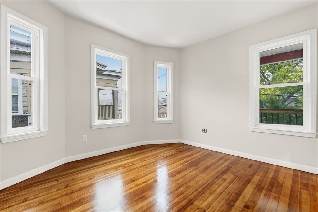 8 1/2 Intervale Street, Unit 10 1/2 Quincy, MA 02169 - Photo 15 of 16 a view of empty room with wooden floor and fan