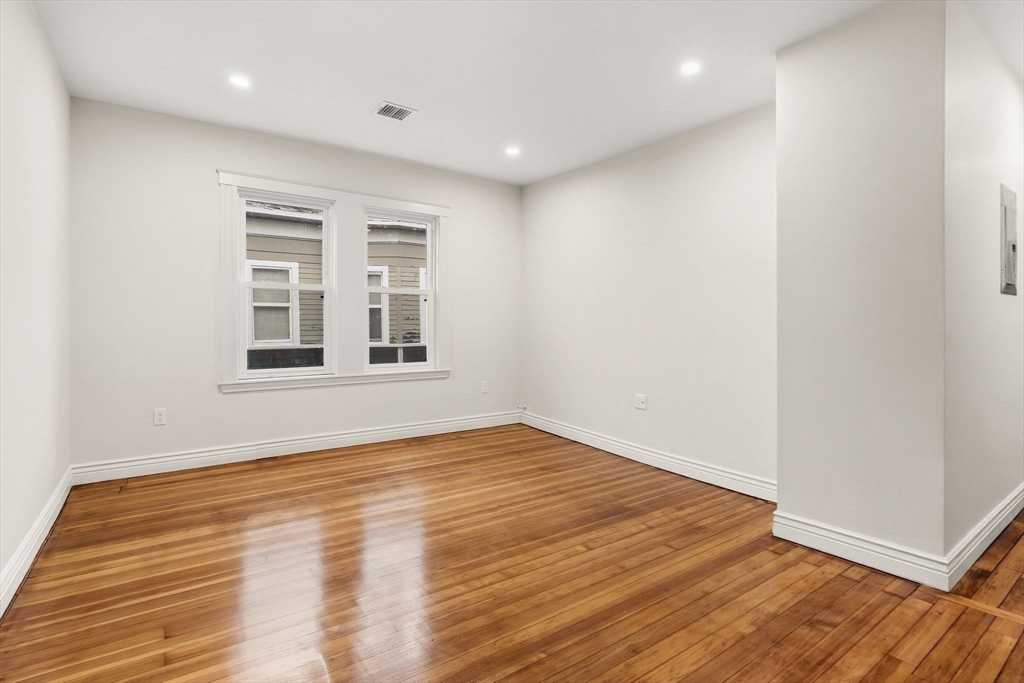 8 1/2 Intervale Street, Unit 10 1/2 Quincy, MA 02169 - Photo 9 of 16 a view of empty room with wooden floor and fan