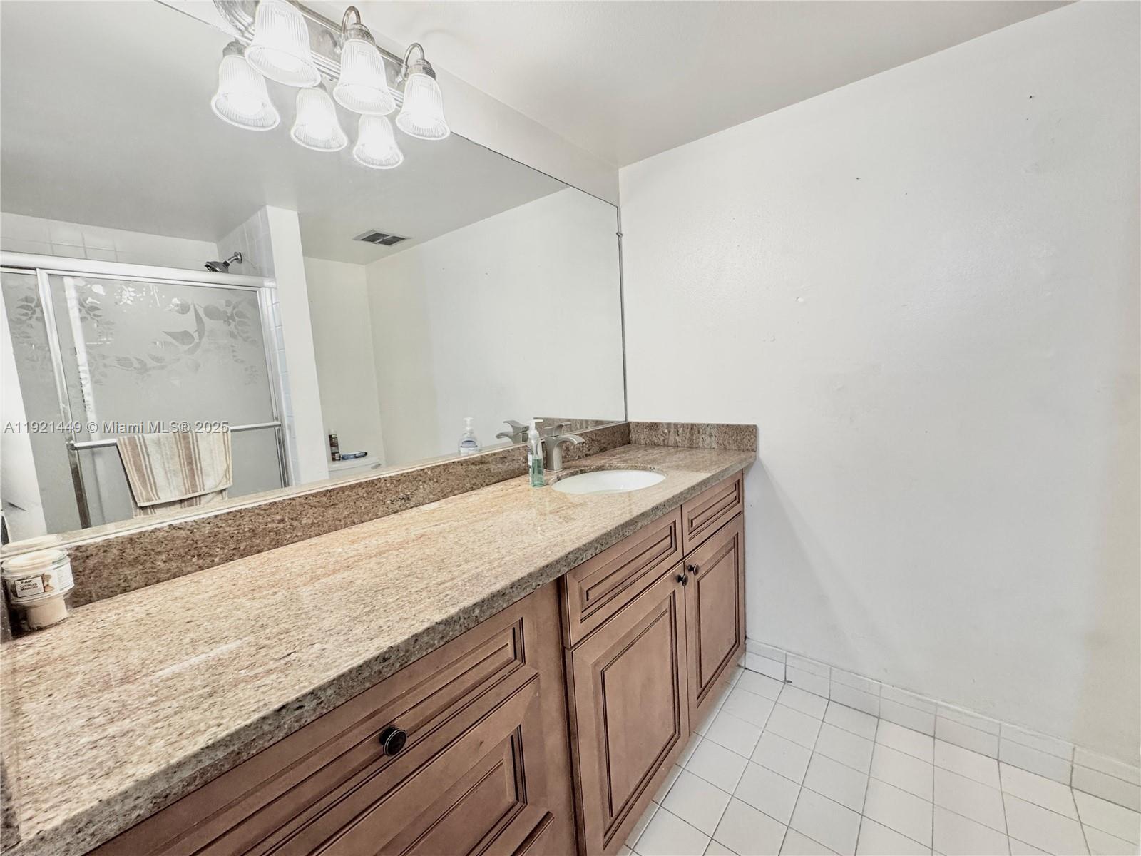 505 South Pine Island Road, Unit 407B Plantation, FL 33324 - Photo 11 of 23 a bathroom with a granite countertop sink and a mirror