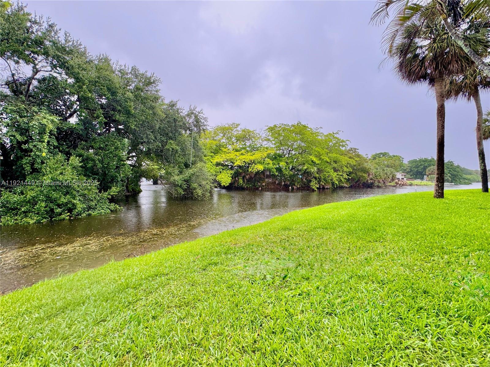 505 South Pine Island Road, Unit 407B Plantation, FL 33324 - Photo 20 of 23 a view of a lake with a house in the background