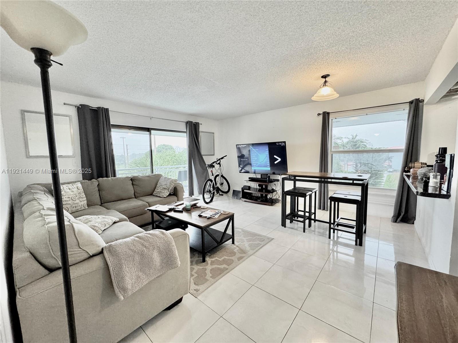 505 South Pine Island Road, Unit 407B Plantation, FL 33324 - Photo 4 of 23 a living room with furniture and a large window