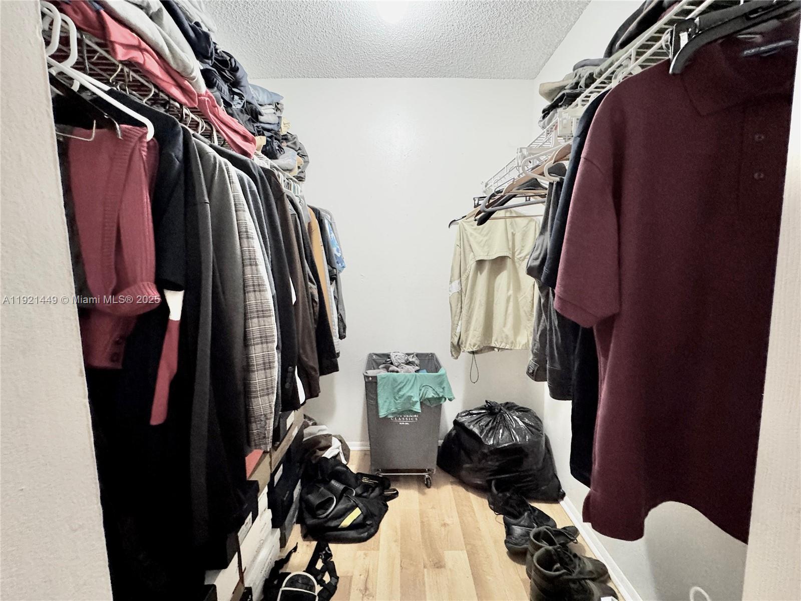 505 South Pine Island Road, Unit 407B Plantation, FL 33324 - Photo 8 of 23 a view of walk in closet with clothes and shoes