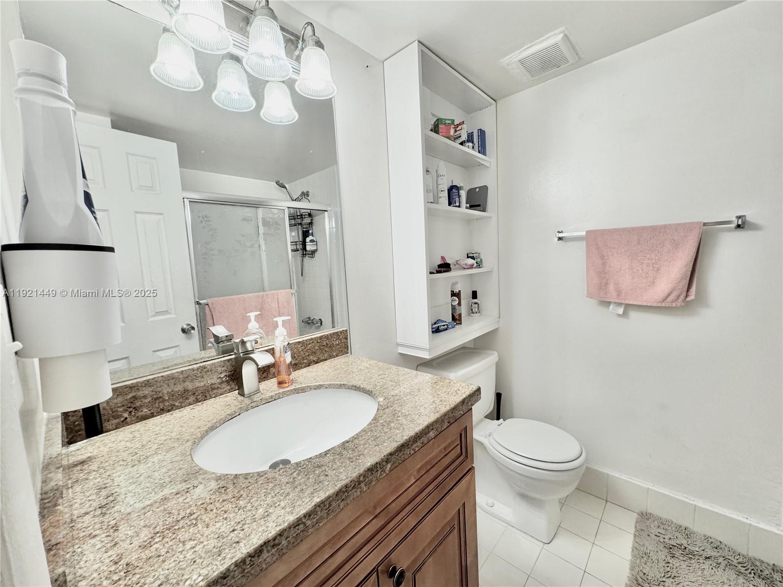 505 South Pine Island Road, Unit 407B Plantation, FL 33324 - Photo 9 of 23 a bathroom with a sink a toilet and a mirror