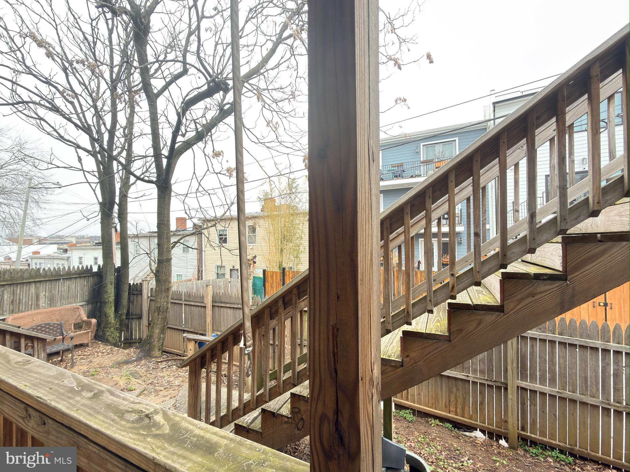 1246 Queen Street Northeast, Unit 2 Washington, DC 20002 - Photo 19 of 23 Charming backyard with wooden stairs and trees.