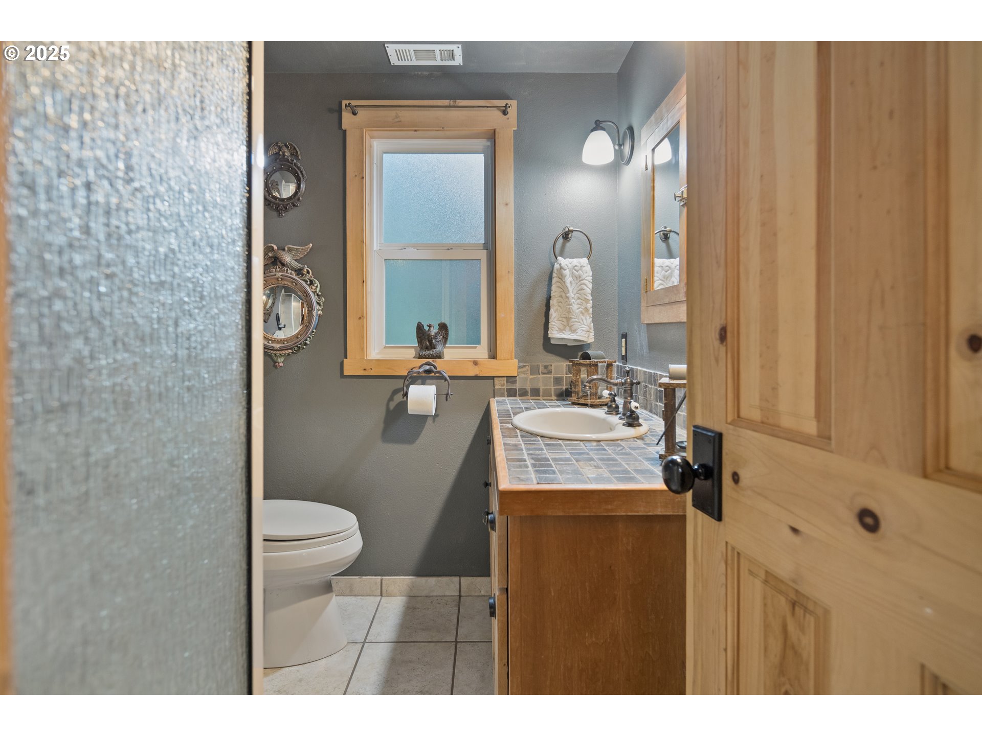 27172 East Marion Road Rhododendron, OR 97049 - Photo 17 of 48 a bathroom with a granite countertop sink a toilet and mirror
